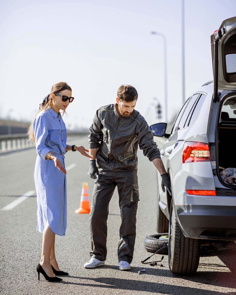 Customer discussing car recovery service with professional service provider in Abu Dhabi